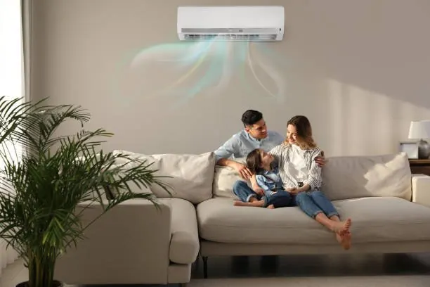 Family relaxing in a cool living room with a ductless mini-split AC